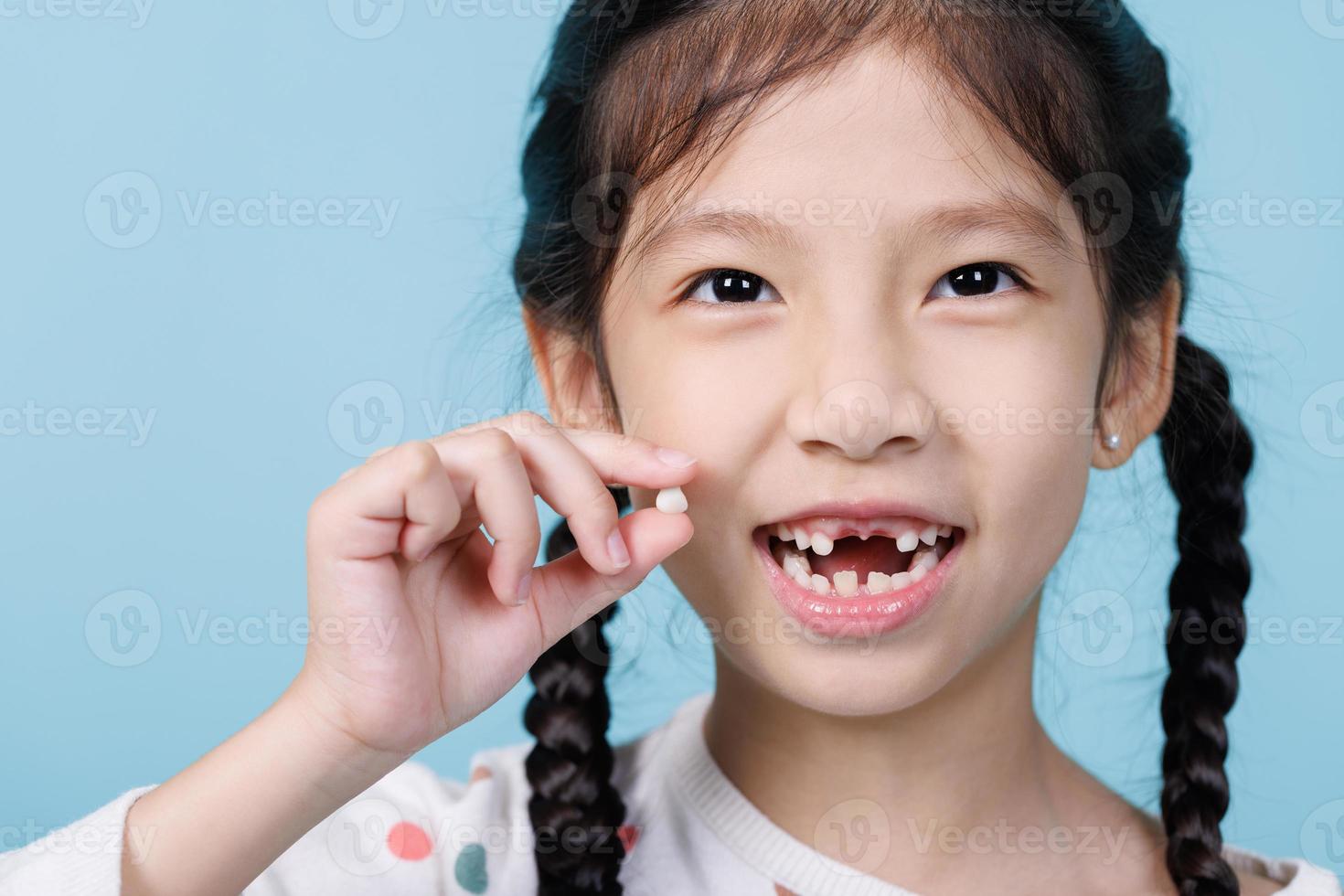 7 Years old child has loose tooth, Dentistry and Health care concept photo