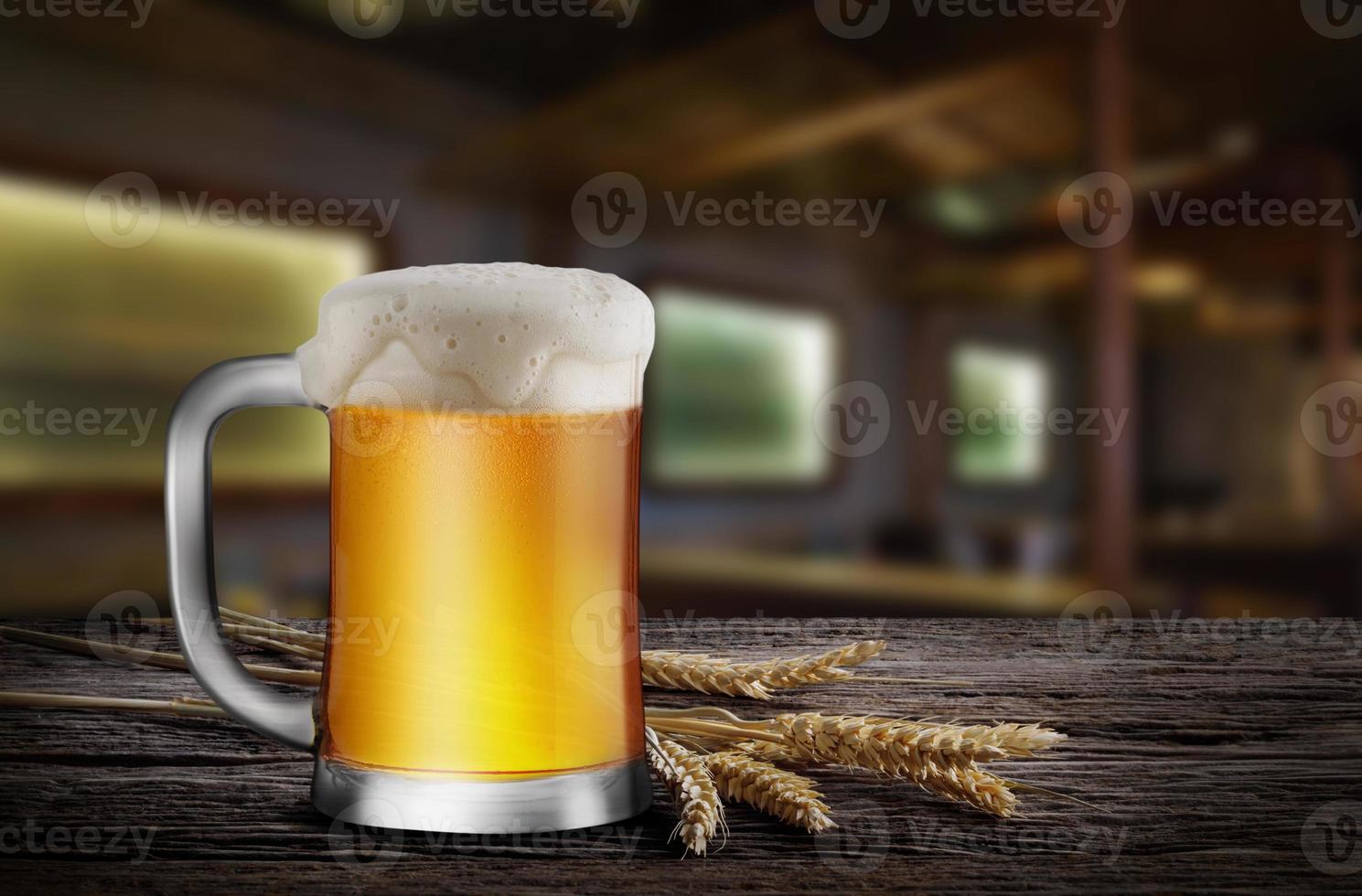 Glass of Light Beer with wheat on the wooden table in the restaurant, with copy space for your text photo