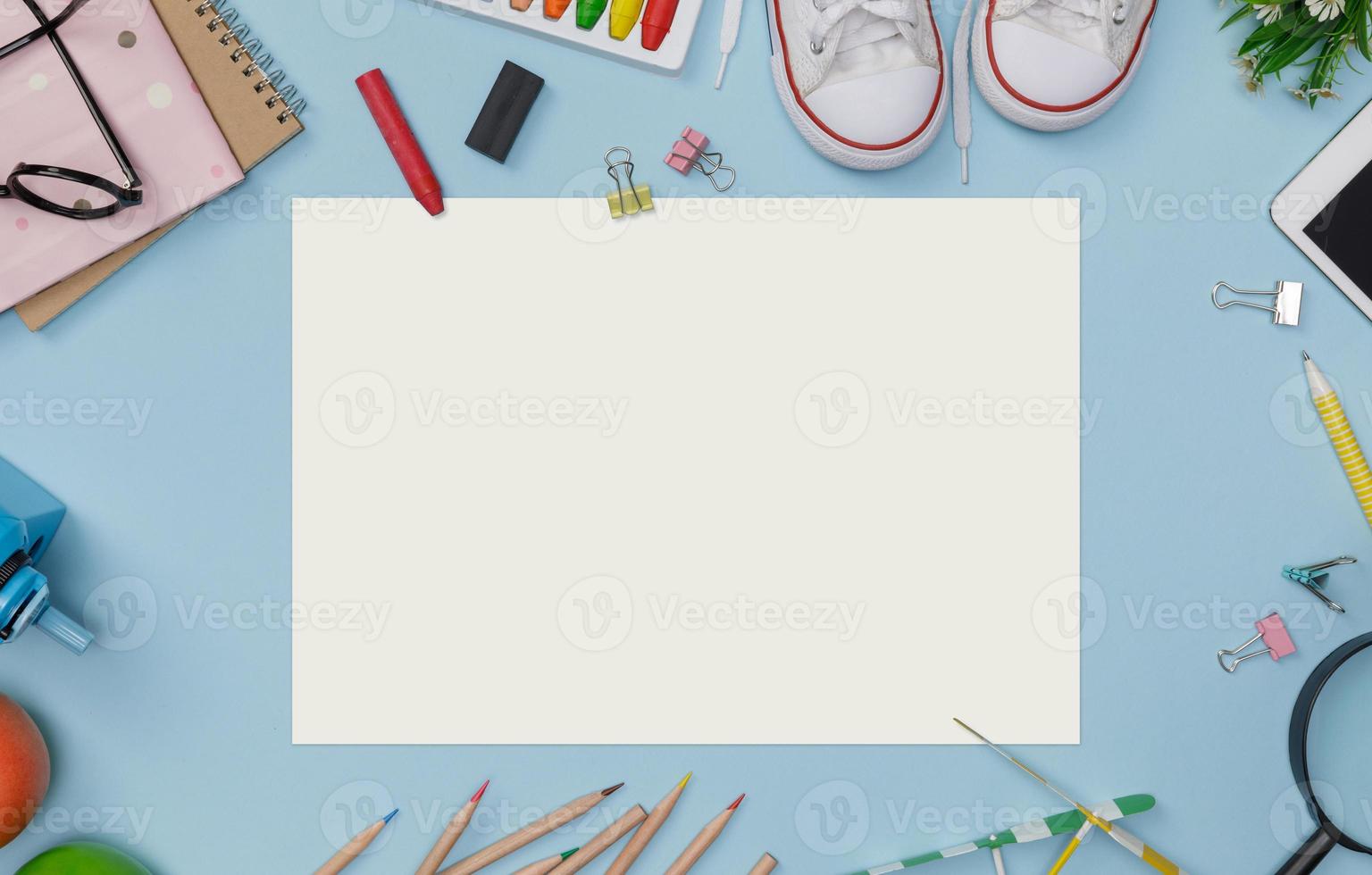 Education's accessories with backpack, student books, shoes, colorful crayon on blackboard background with copy space mockup template photo