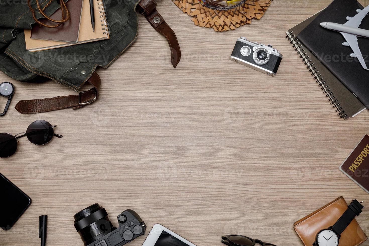 Top view mockup of Traveler's accessories with passport, books of travel plan, wallet, camera, hat, backpack and airplane toy on brown wooden desk empty space, Travel concept background photo