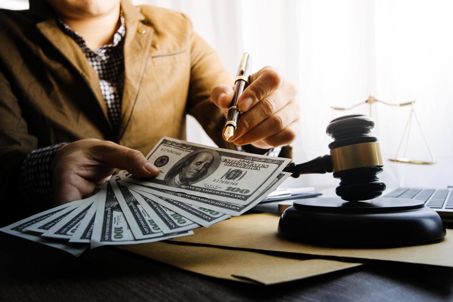 Business and lawyers discussing contract papers with brass scale on desk in office. Law, legal services, advice, justice and law concept picture with film grain effect photo