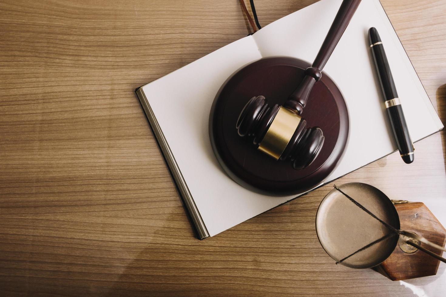 Business and lawyers discussing contract papers with brass scale on desk in office. Law, legal services, advice, justice and law concept picture with film grain effect photo