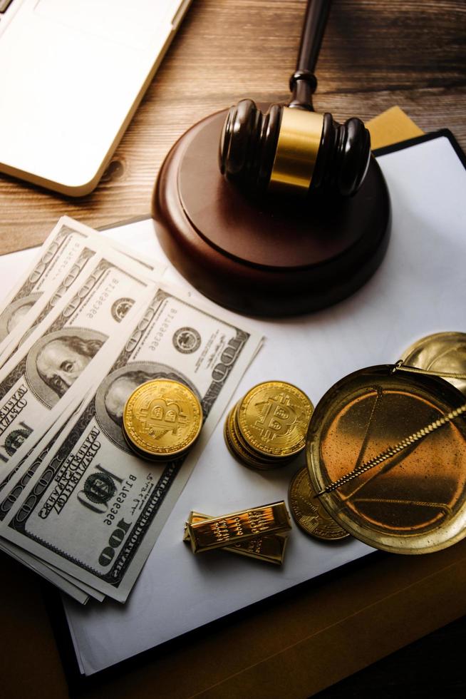 Justice and law concept.Male judge in a courtroom with the gavel, working with, computer and docking keyboard, eyeglasses, on table in morning light photo