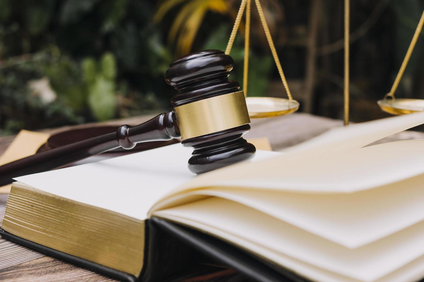 Business and lawyers discussing contract papers with brass scale on desk in office. Law, legal services, advice, justice and law concept picture with film grain effect photo