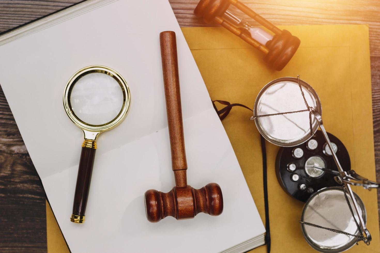 Business and lawyers discussing contract papers with brass scale on desk in office. Law, legal services, advice, justice and law concept picture with film grain effect photo