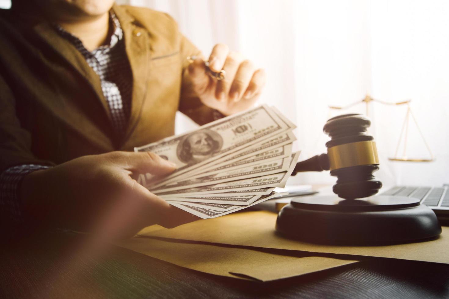 Business and lawyers discussing contract papers with brass scale on desk in office. Law, legal services, advice, justice and law concept picture with film grain effect photo