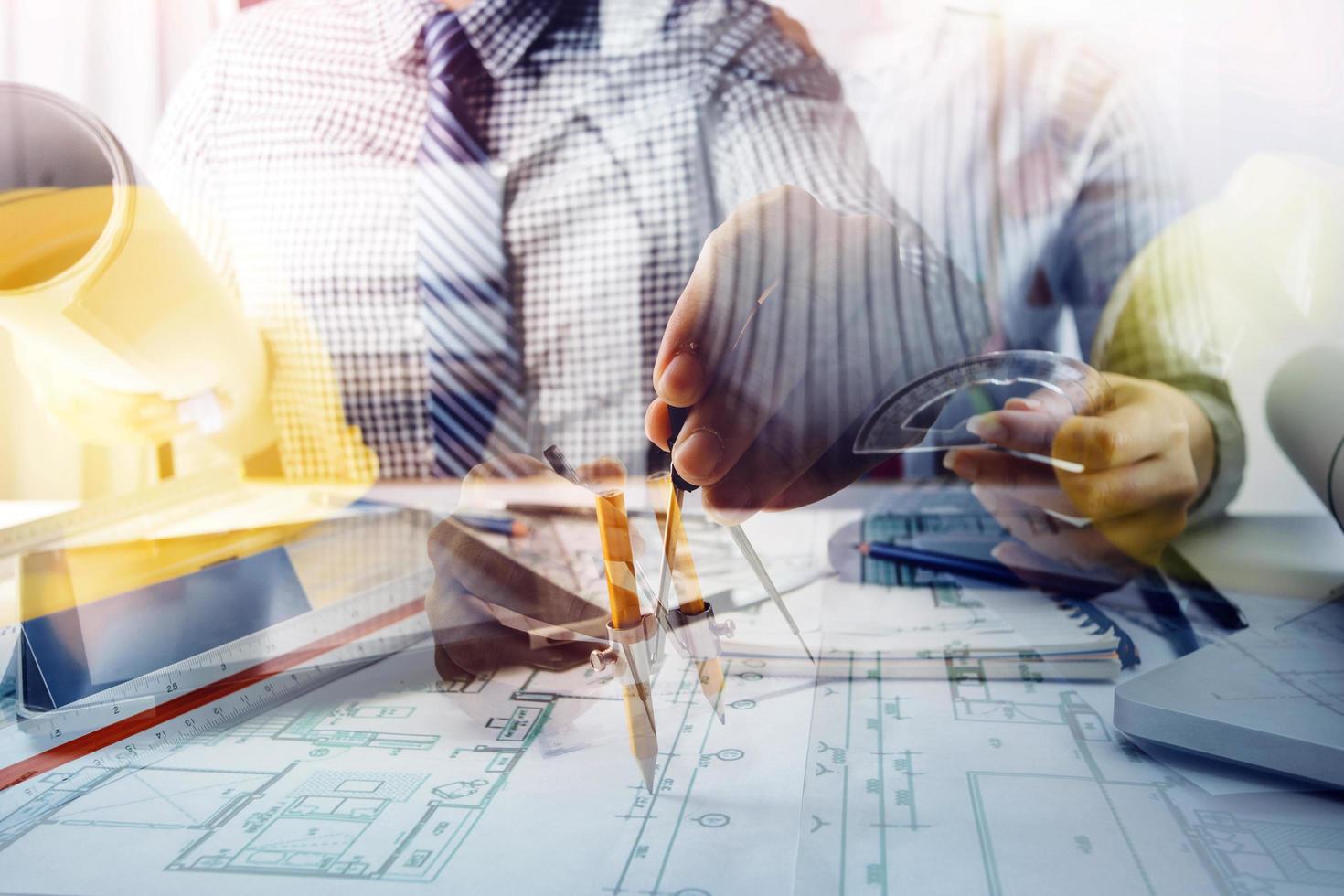 business hand working and laptop with on on architectural project at construction site at office desk in office photo