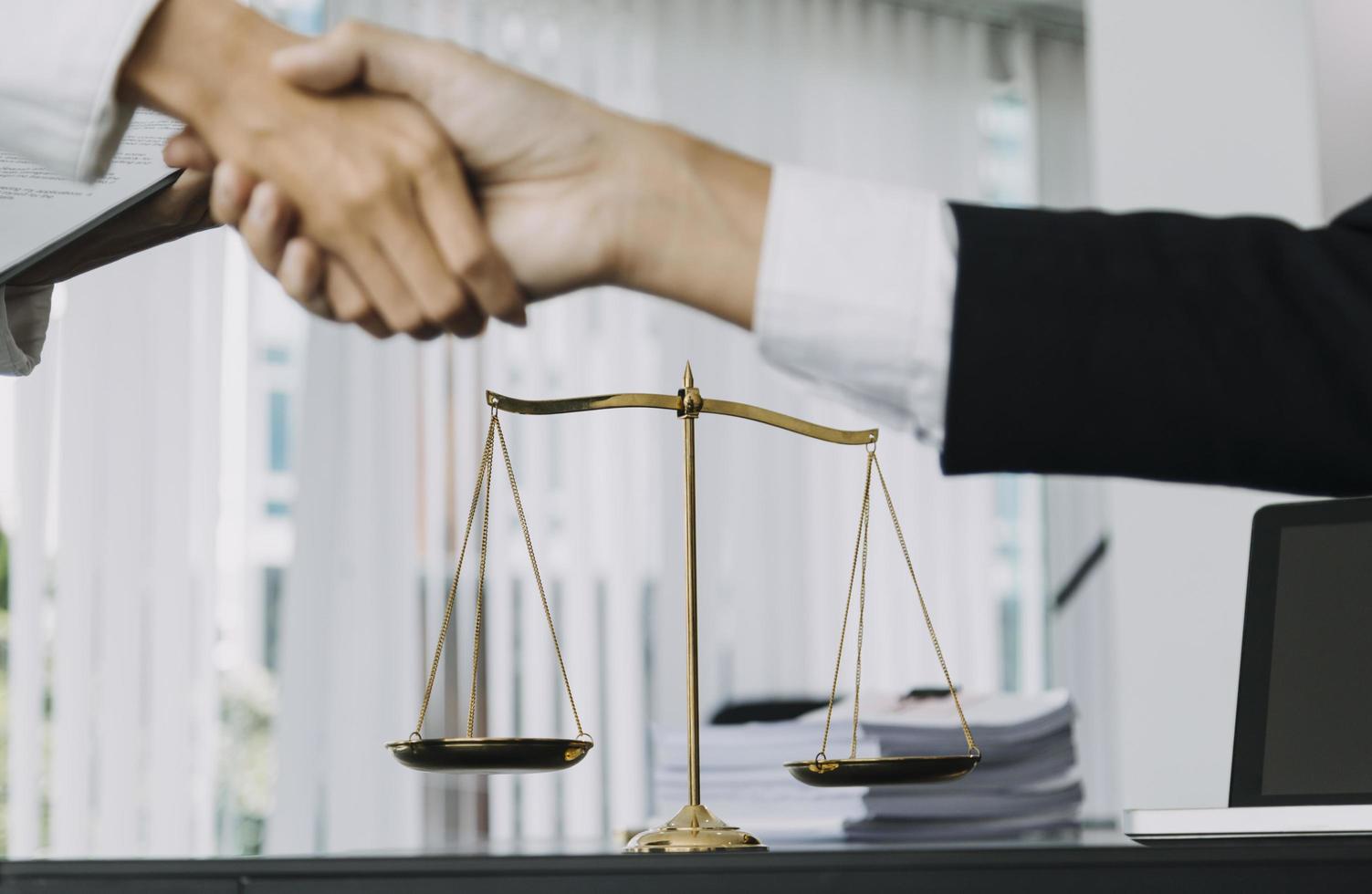 Justice and law concept. Gavel on sounding block in hand's Male judge at a courtroom, working with document law books, report the case on table in modern office. photo