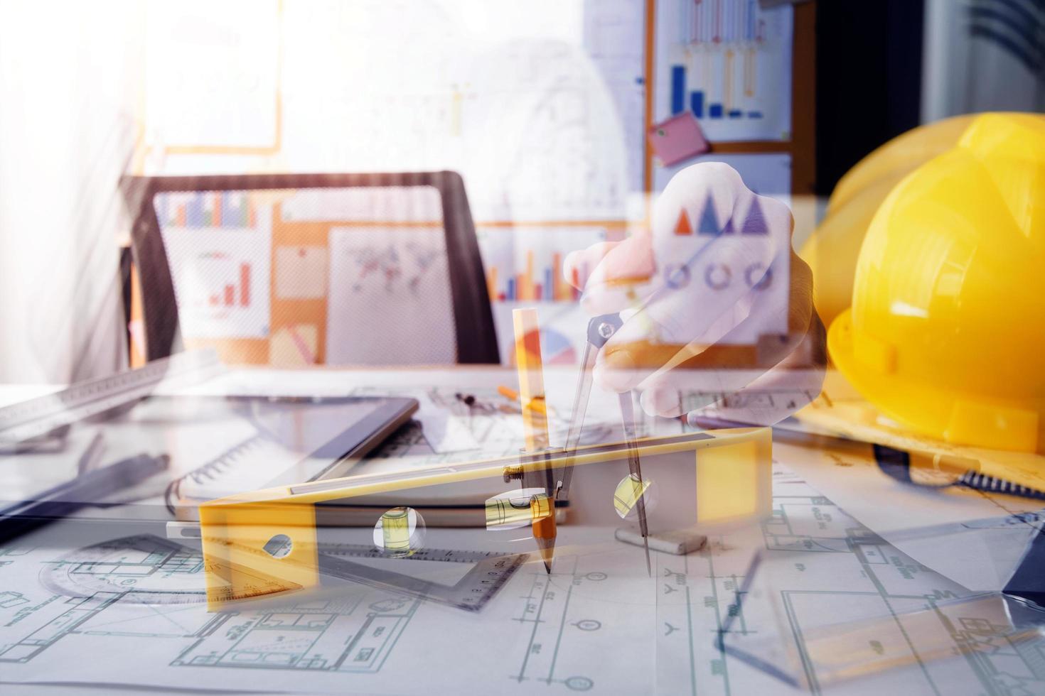 business hand working and laptop with on on architectural project at construction site at office desk in office photo