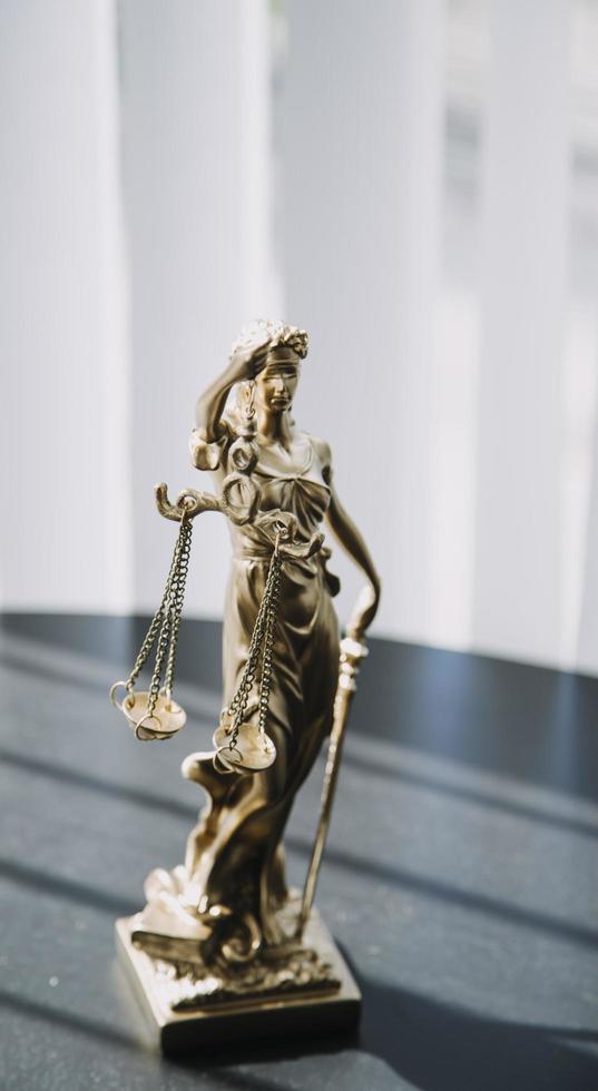 Justice and law concept. Gavel on sounding block in hand's Male judge at a courtroom, working with document law books, report the case on table in modern office. photo