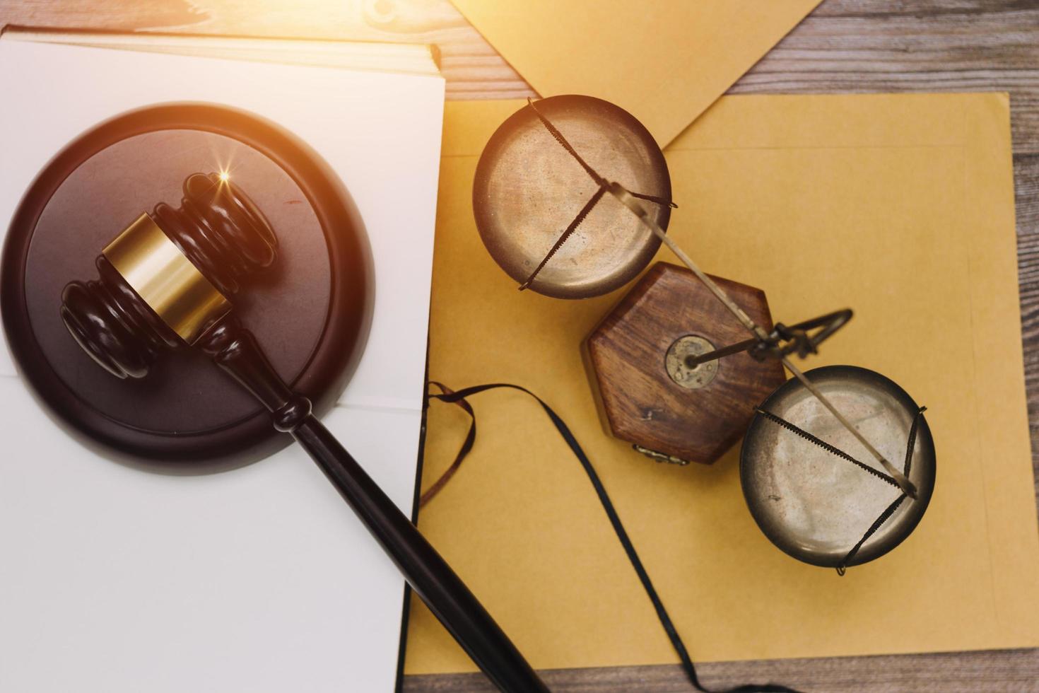 Business and lawyers discussing contract papers with brass scale on desk in office. Law, legal services, advice, justice and law concept picture with film grain effect photo