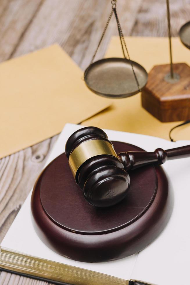 Business and lawyers discussing contract papers with brass scale on desk in office. Law, legal services, advice, justice and law concept picture with film grain effect photo