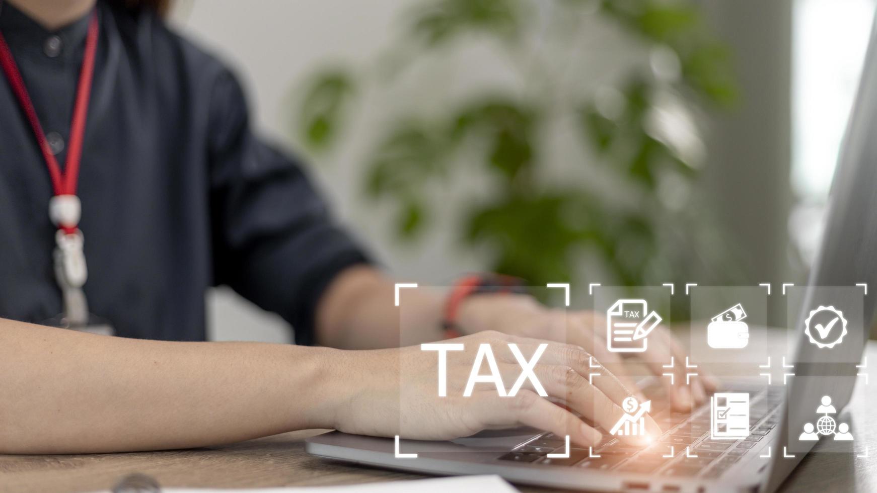 Businesswoman use a computer to complete Individual income tax return forms online for tax payment. Government, state taxes. Data analysis, financial research, report. Calculation of tax return. photo