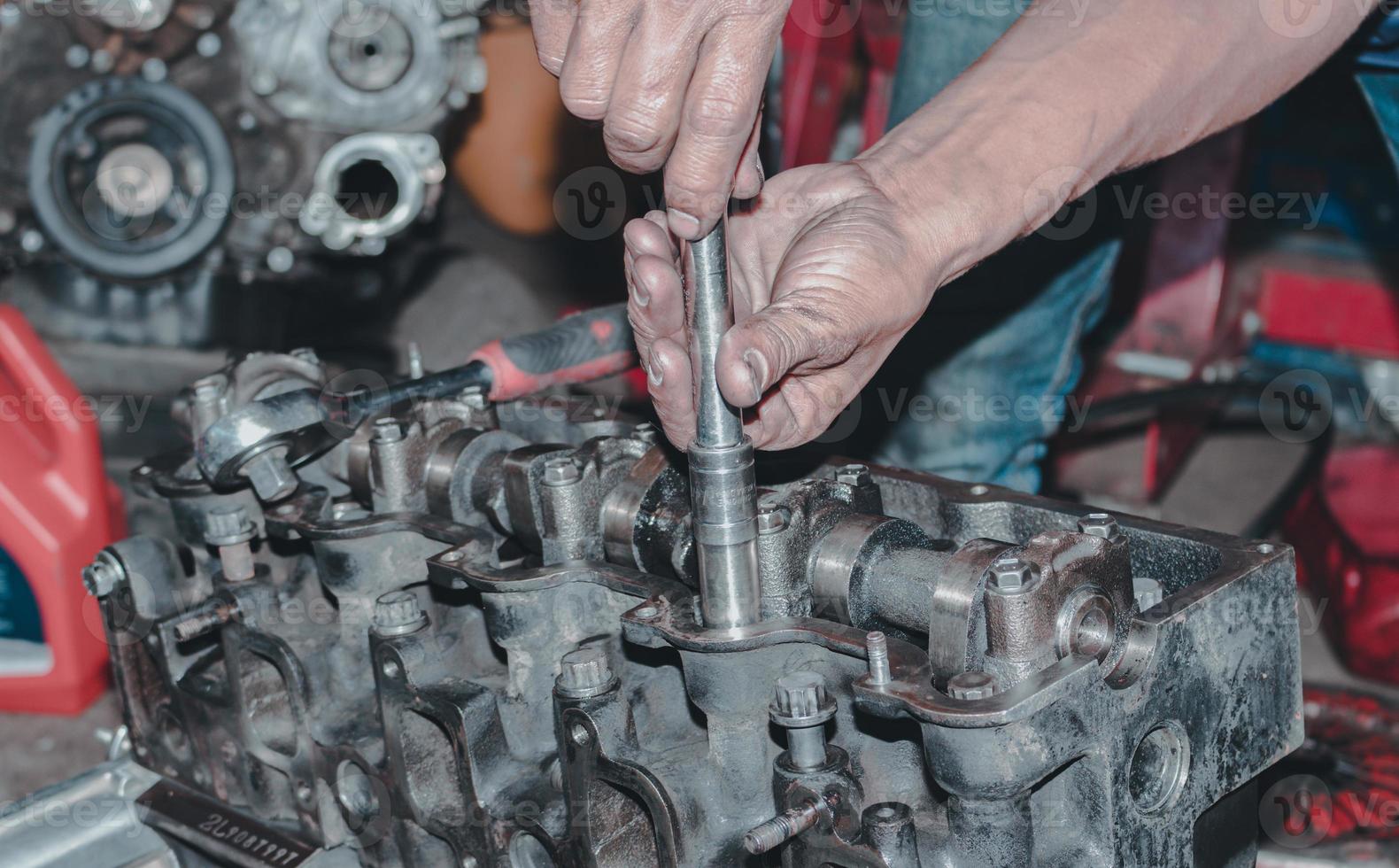 The mechanic is checking the engine. photo