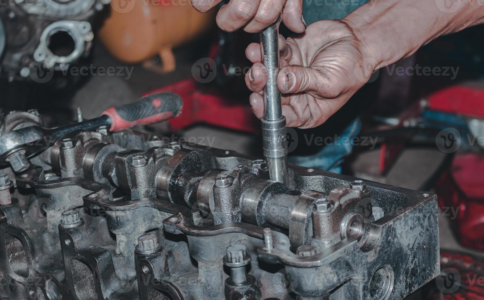 The mechanic is checking the engine. photo