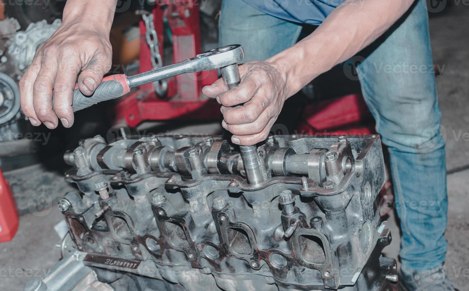 The mechanic is checking the engine. photo
