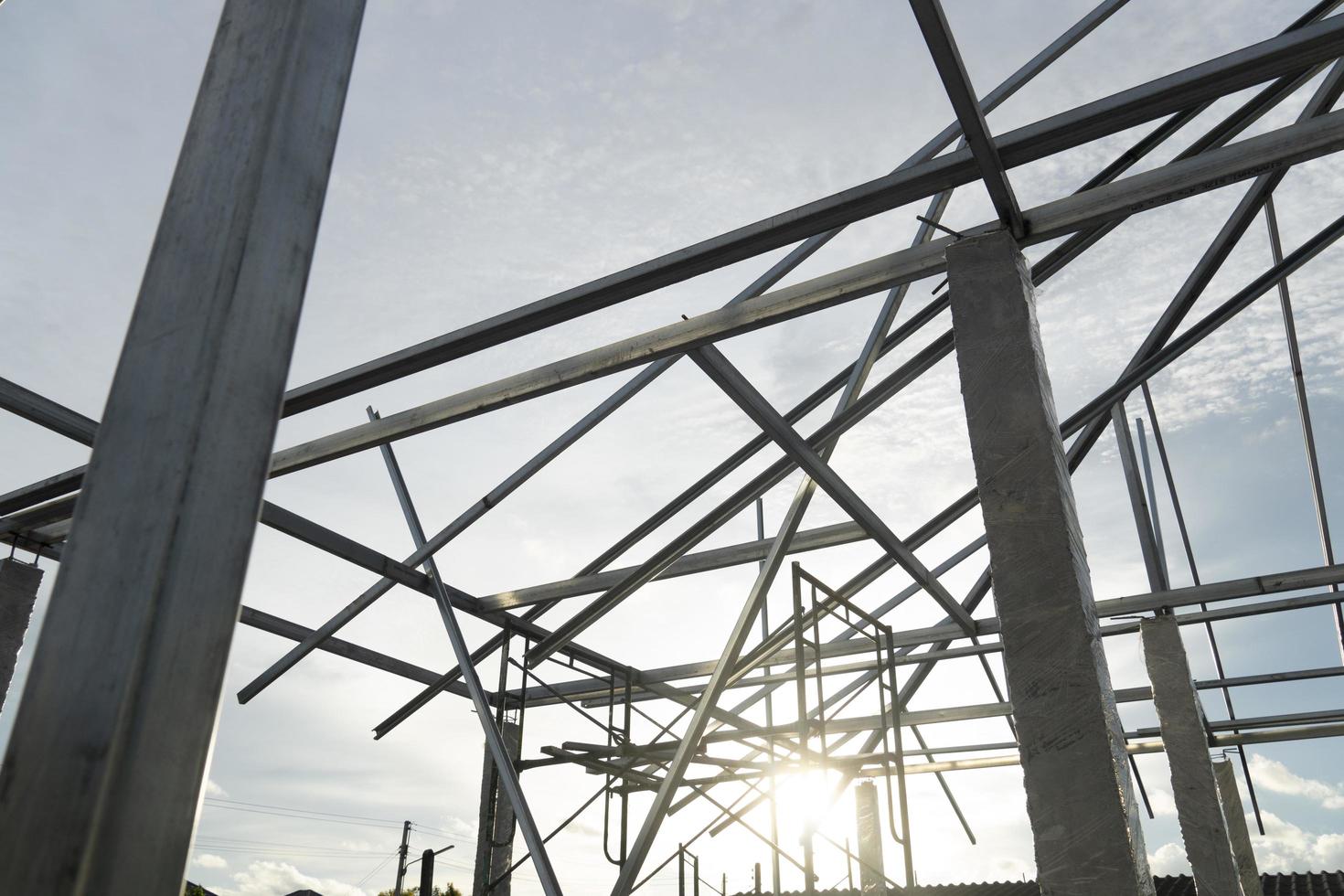 Steel roof structure connected to cement columns under the sky. with sunlight in the evening. photo