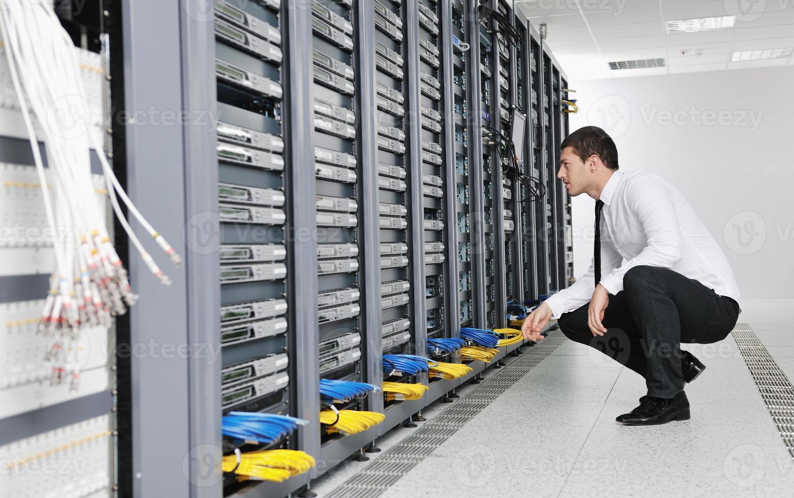 young it engeneer in datacenter server room photo