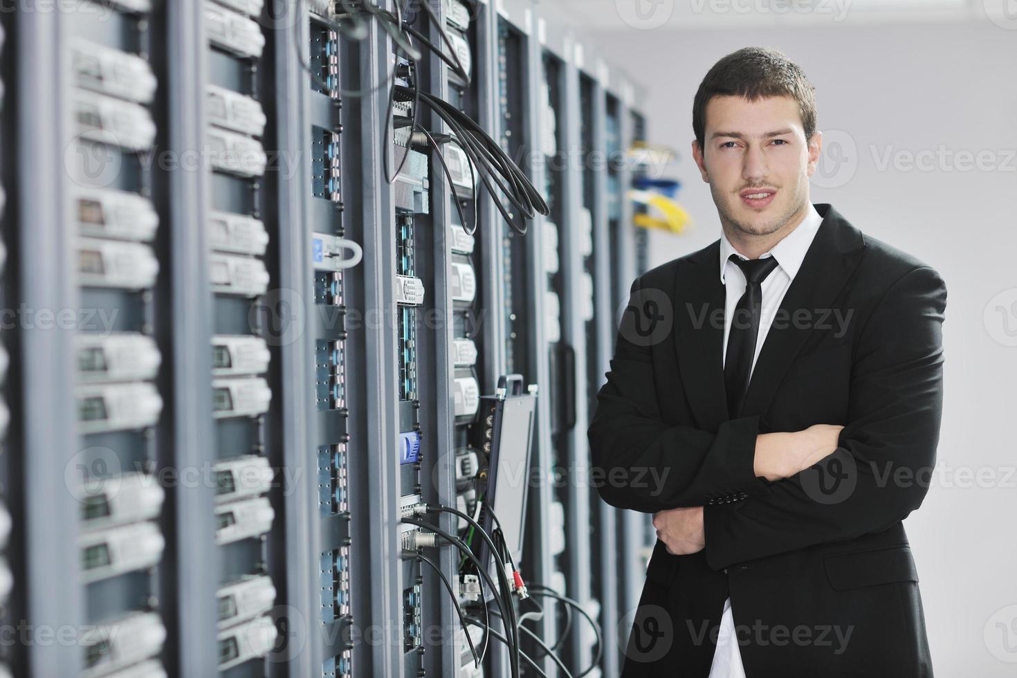 young engeneer in datacenter server room photo