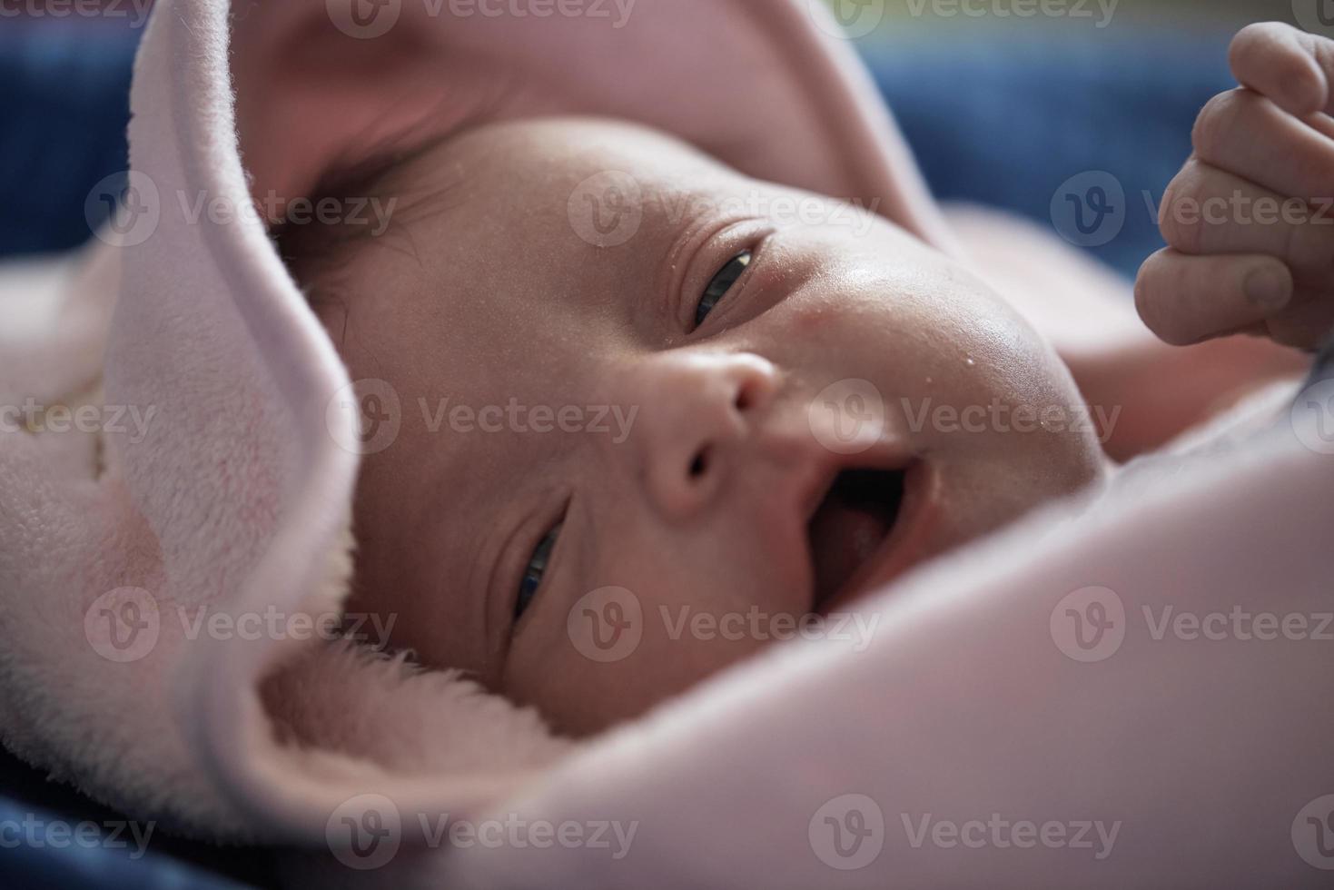 One month newborn baby sleeping  in bed photo