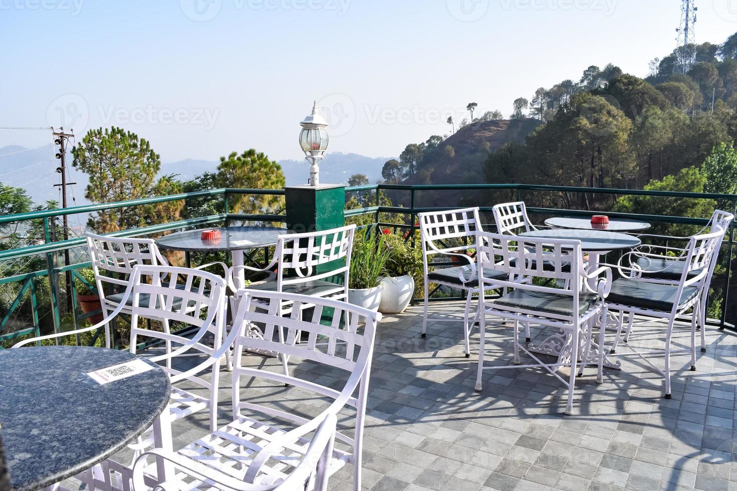 Early morning view of Modern rooftop restaurant at Kasauli, Himachal Pradesh in India, View of mountain hills from open air restaurant in Kasauli, Kasauli Rooftop restaurant photo