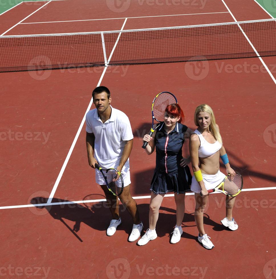 happy young couple play tennis game outdoor photo