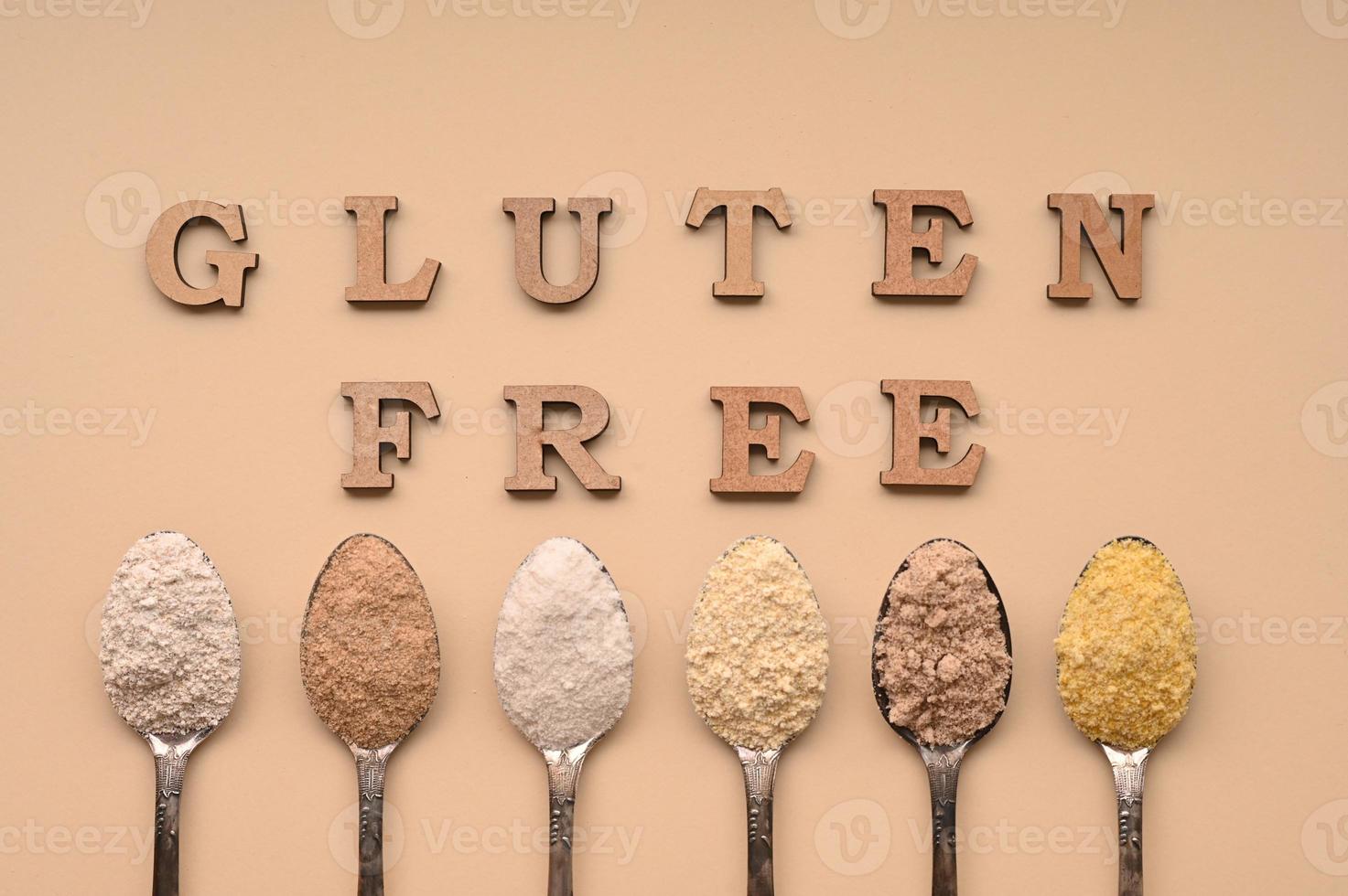 Gluten free text and spoons of various gluten free flour. Flat lay, top. photo