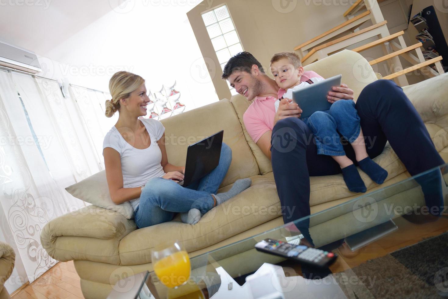 family at home using tablet computer photo