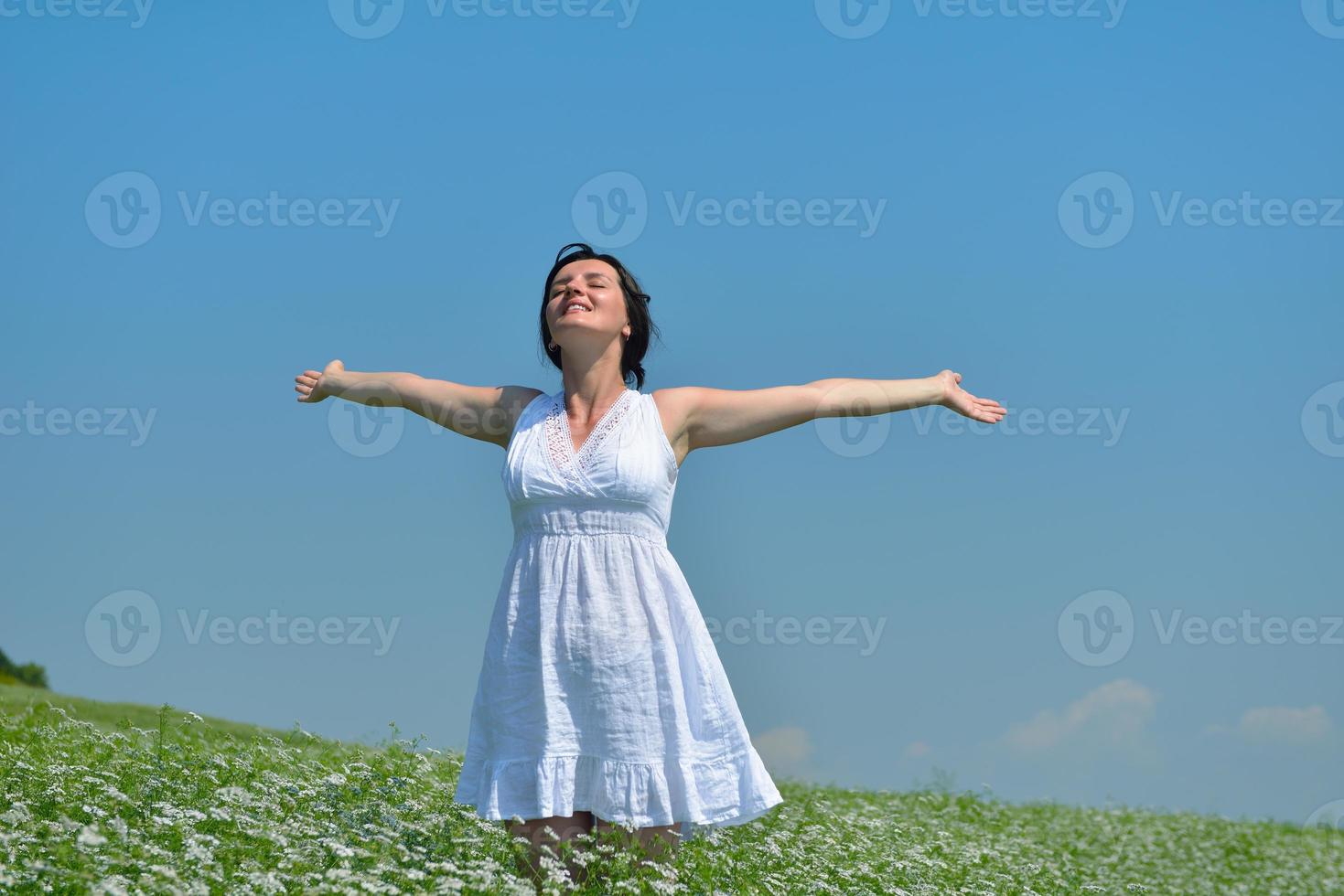 Young happy woman in green field photo