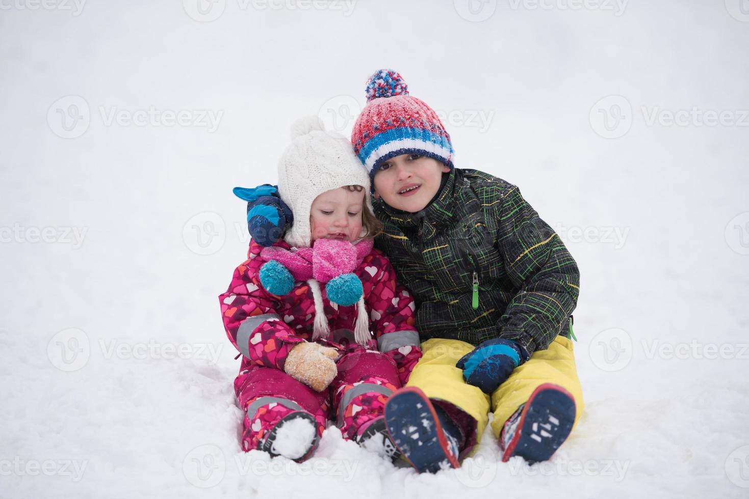children group  having fun and play together in fresh snow photo
