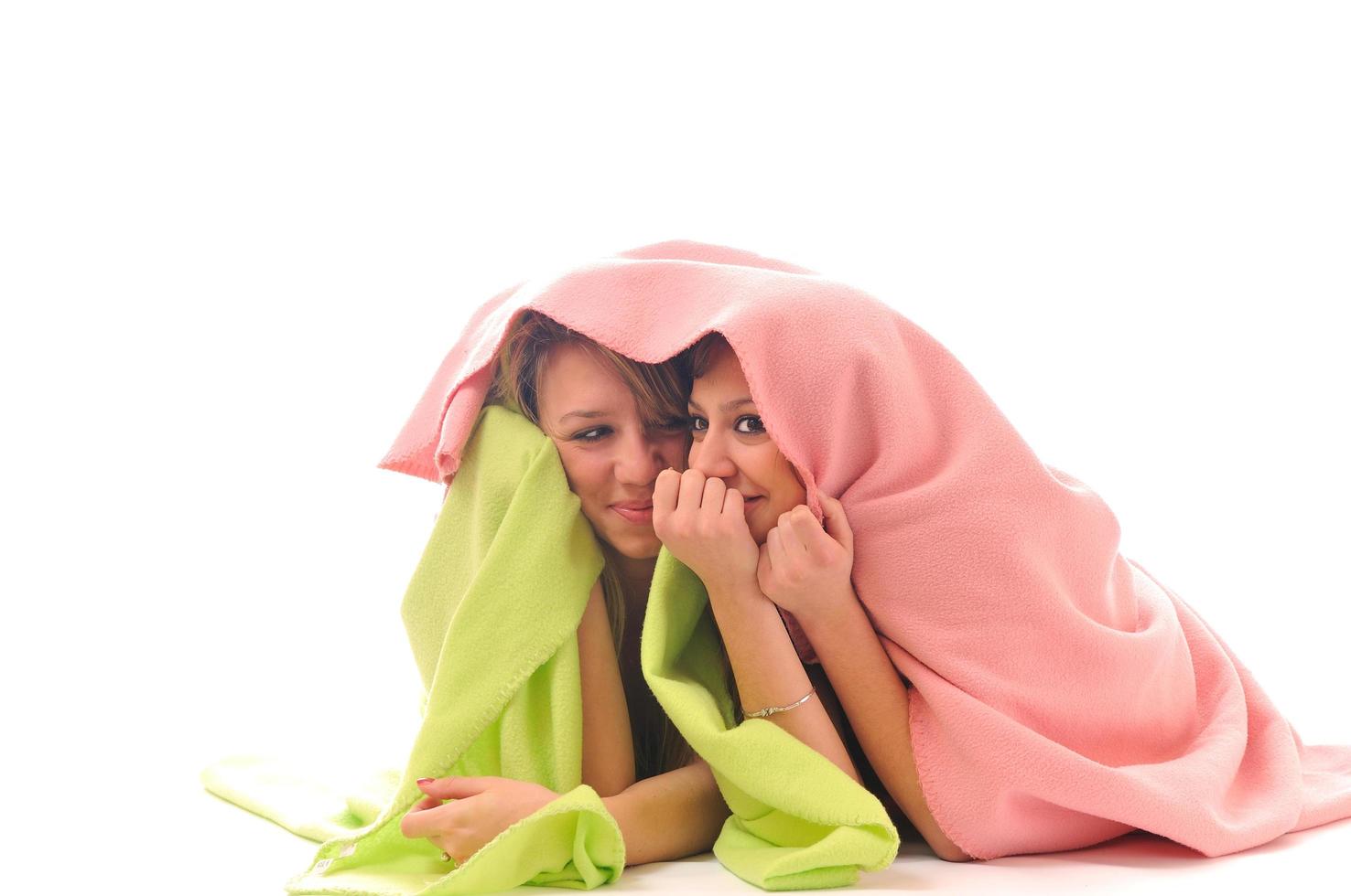 young girls under blanket smile photo