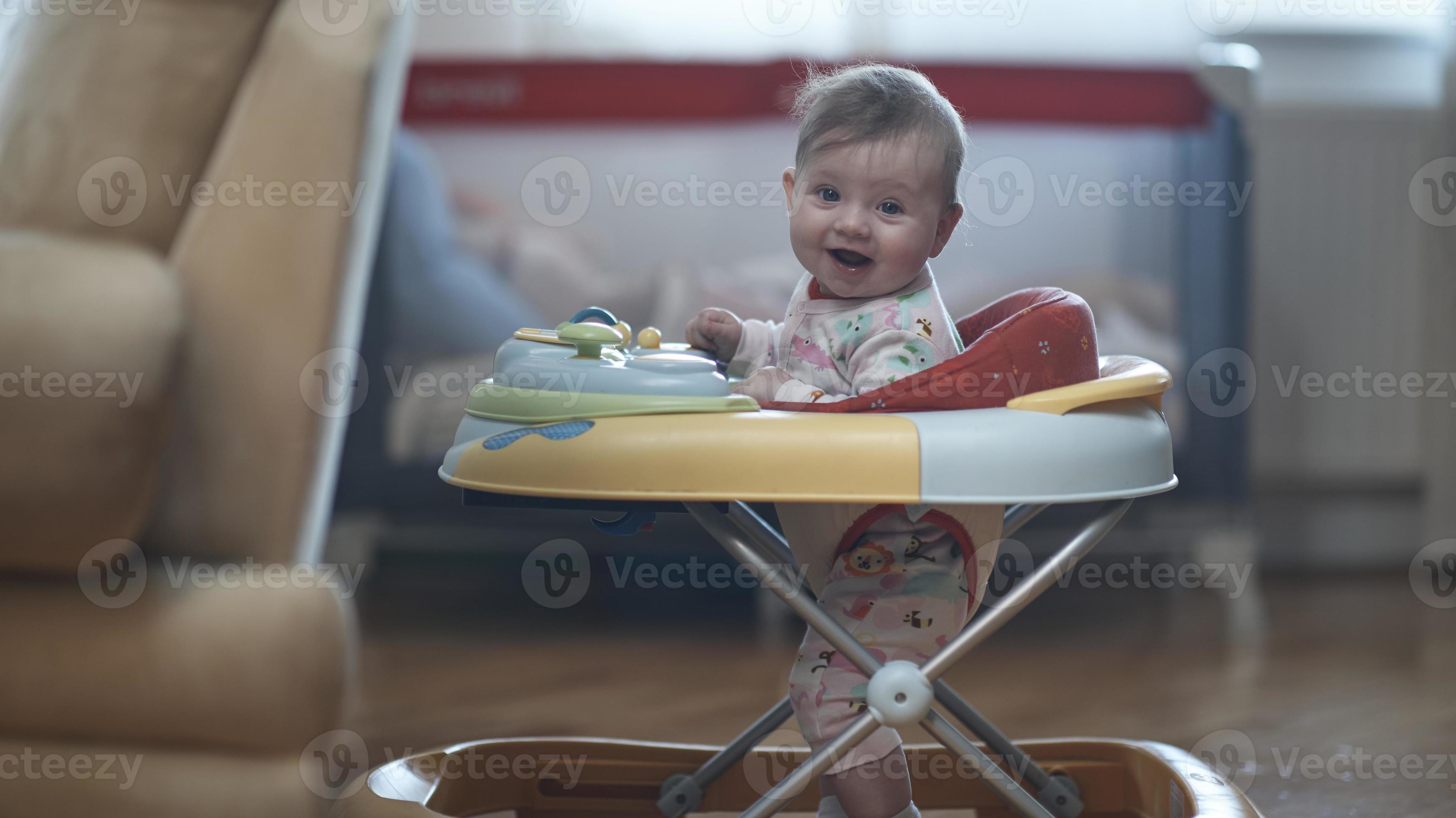 baby learning to walk in walker 11573929 Stock Photo at Vecteezy