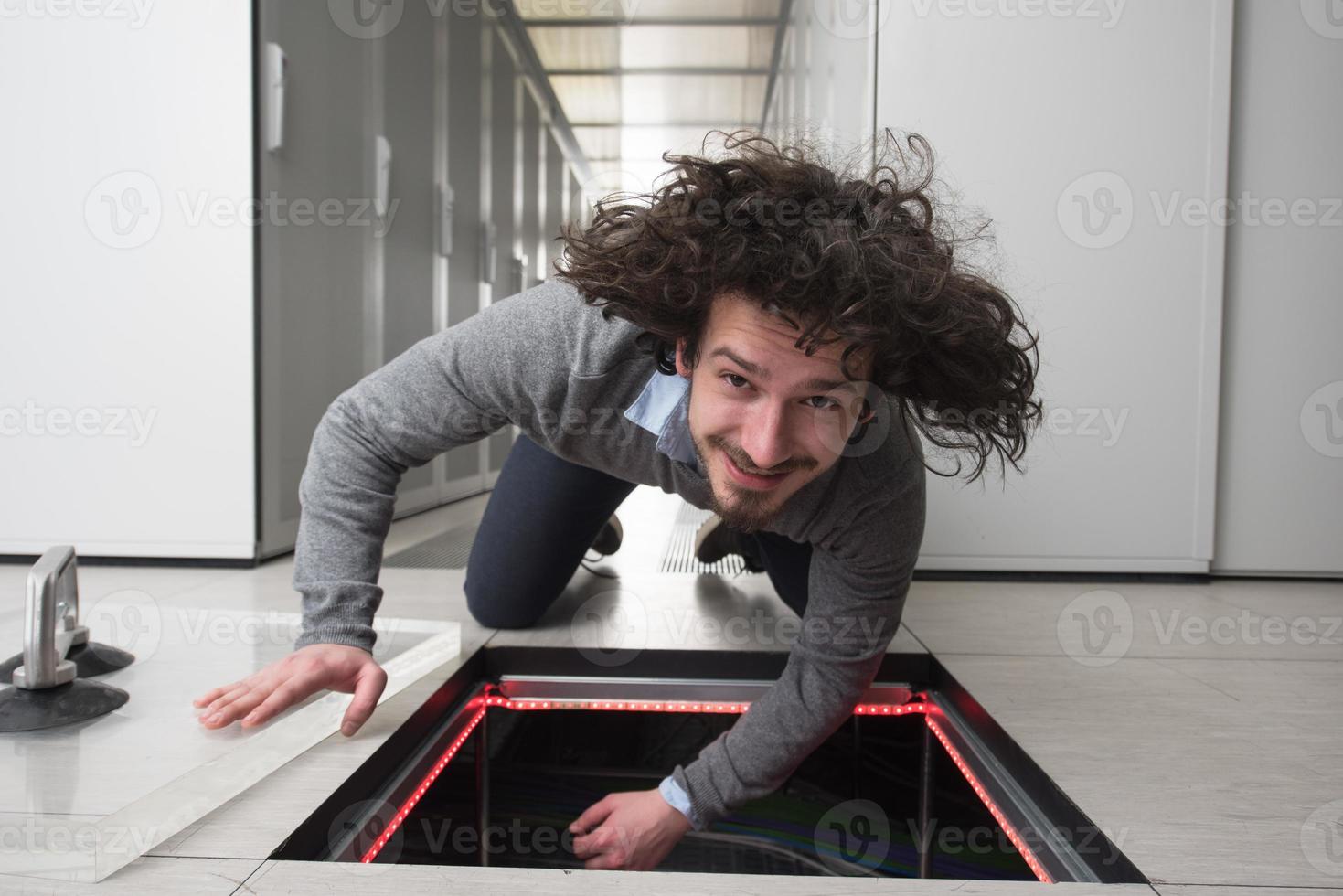 engineer connecting cables in server room photo