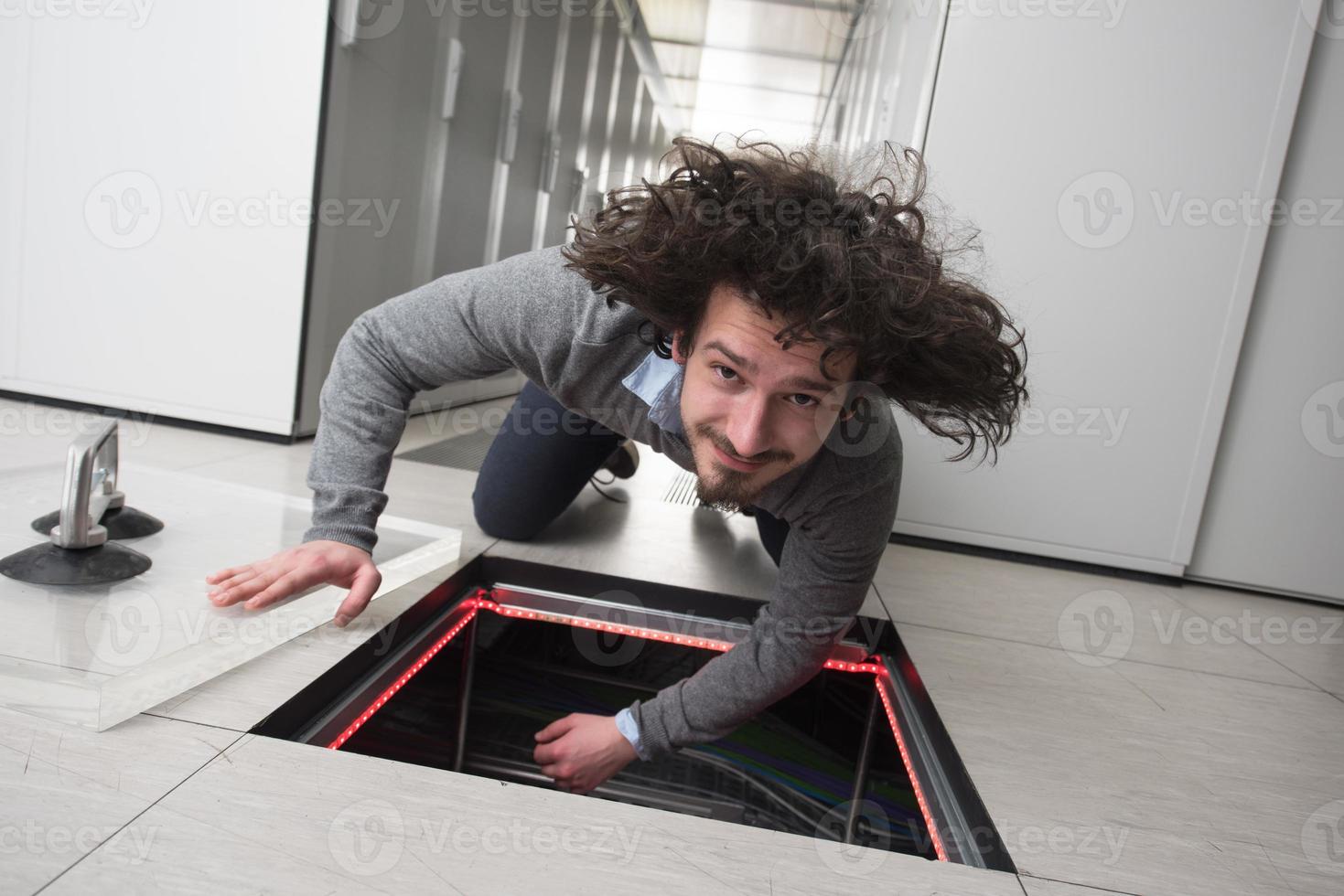 engineer connecting cables in server room photo