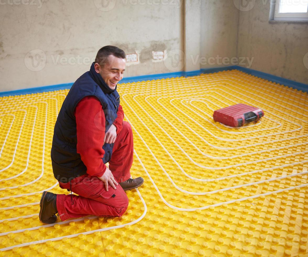 workers installing underfloor heating system 11574013 Stock Photo at