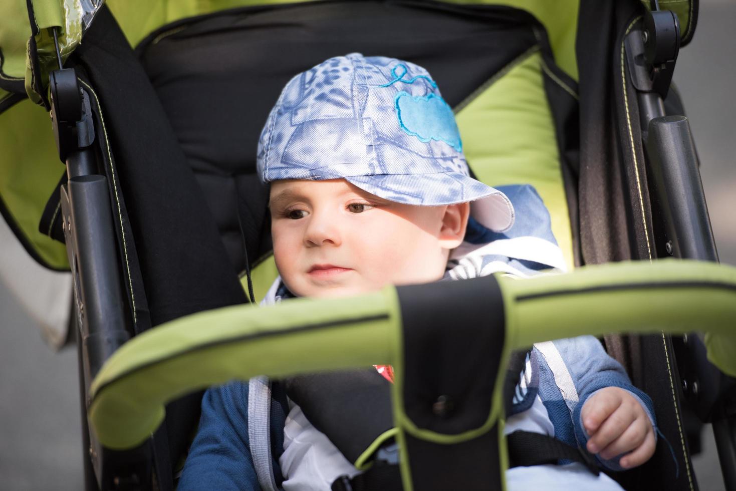 baby boy sitting in the pram photo