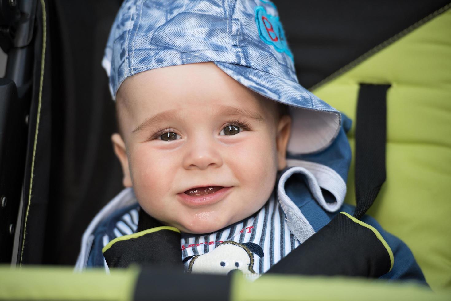 baby boy sitting in the pram photo