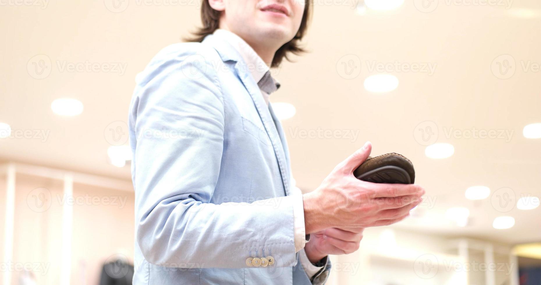 Man Chooses Shoes At Shoe Store photo