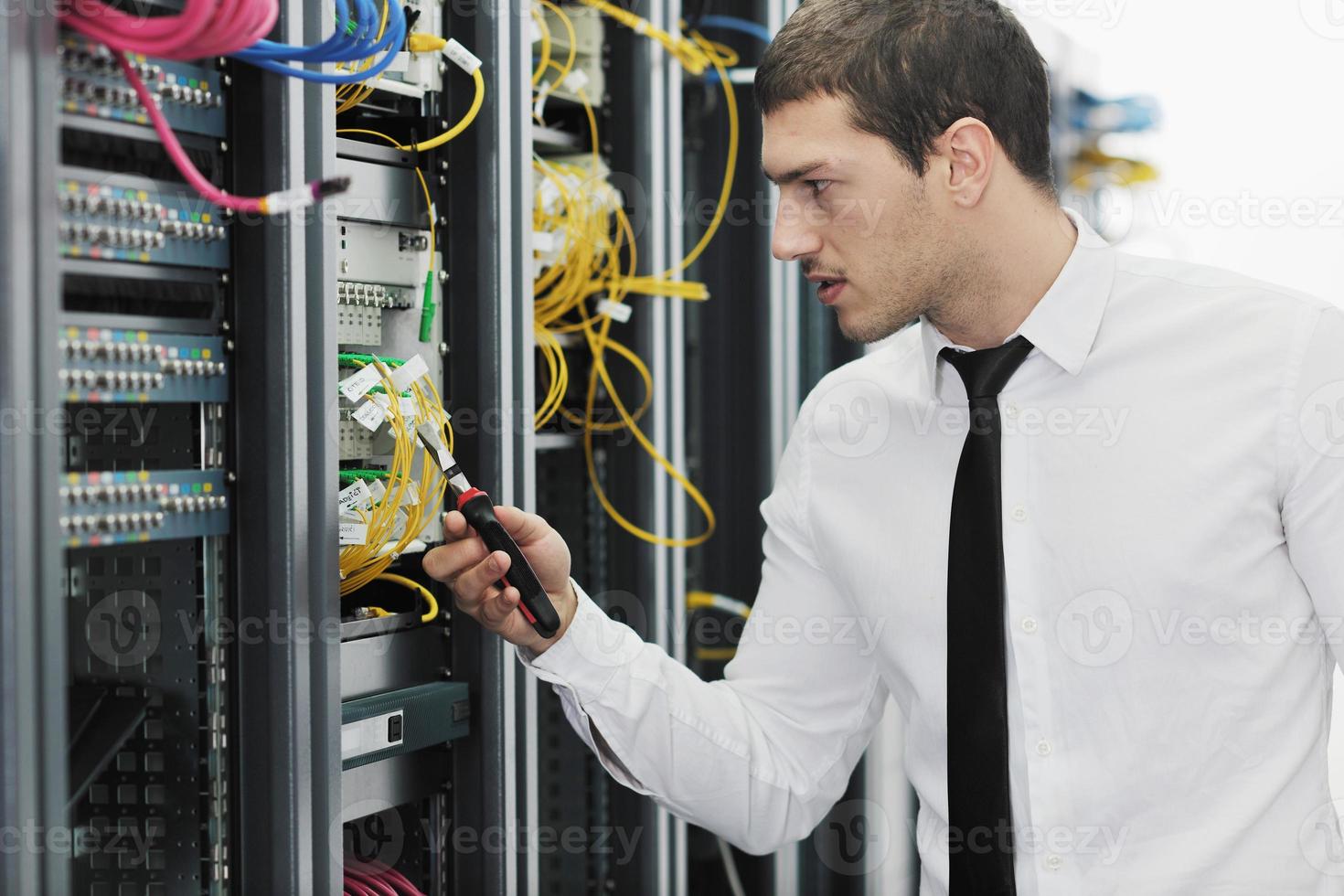 young it engeneer in datacenter server room photo