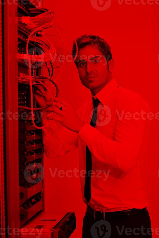 young it engineer in datacenter server room photo