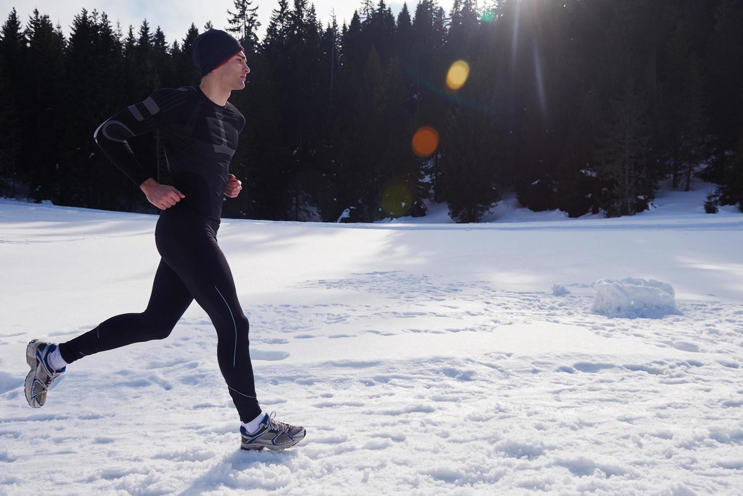 jogging on snow in forest photo