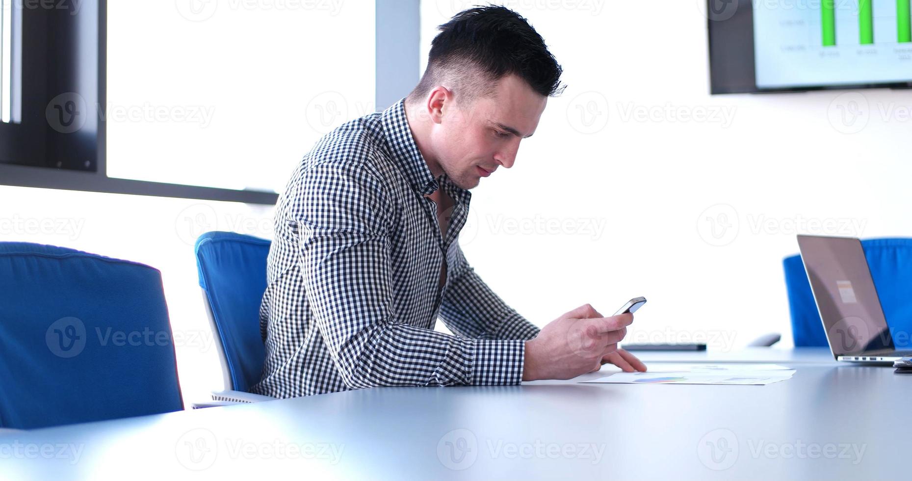 Senior businessman  using cell phone at  stratup office photo
