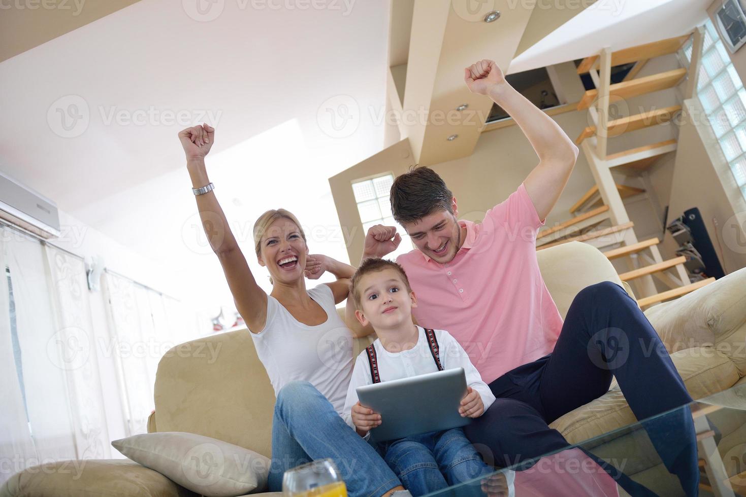 family at home using tablet computer photo