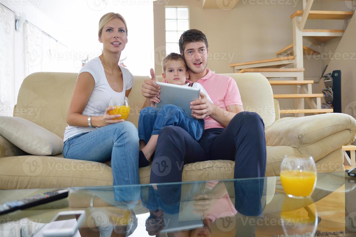 family at home using tablet computer photo