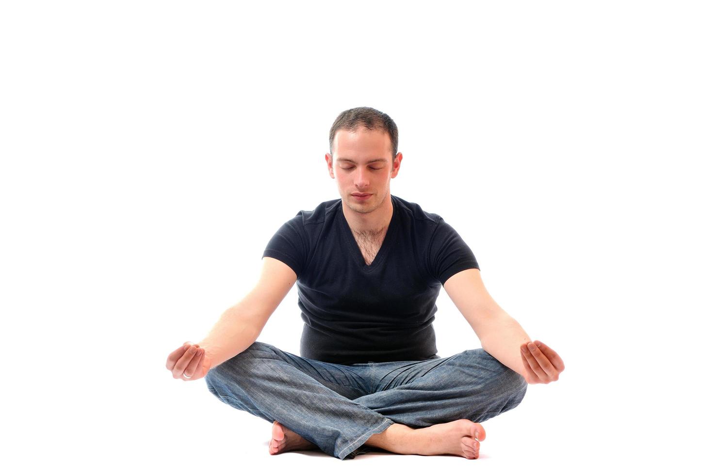 young man in lotus position exercising yoga photo