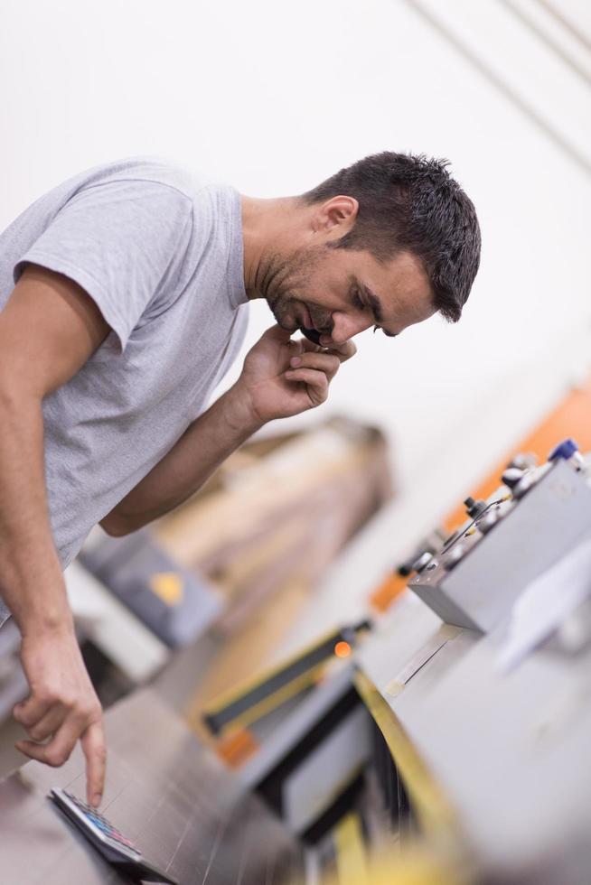 engineer in front of wood cutting machine photo