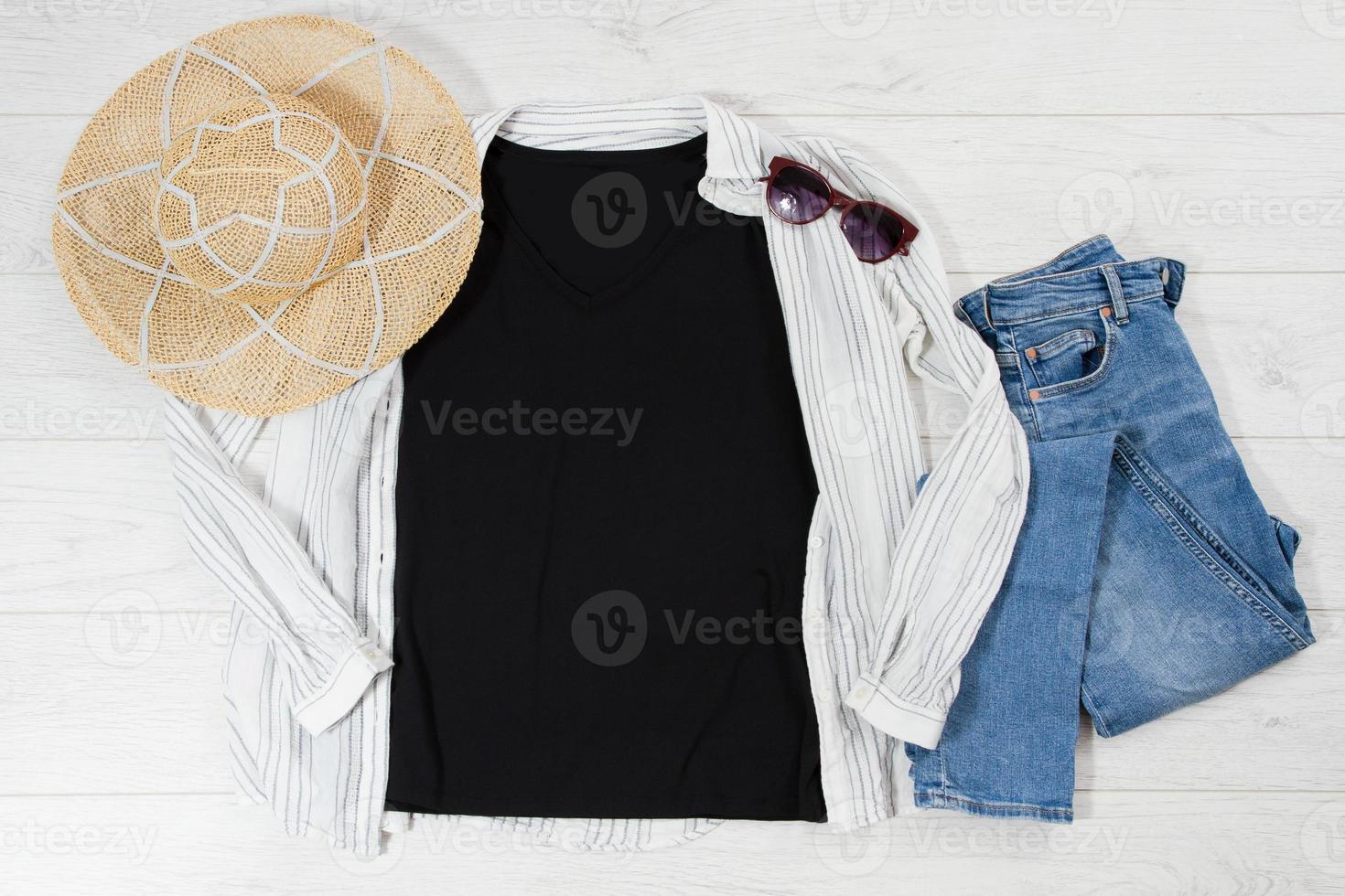 Black closeup t shirt mock up flat lay on white wooden background. Top view and copy space. Mockup t-shirt and summertime. Template blank shirt. photo