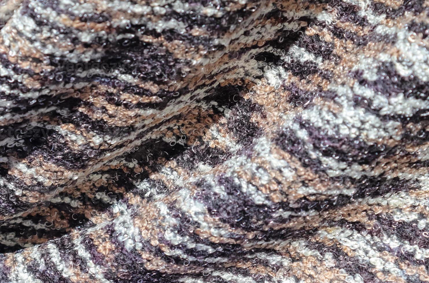 Detailed close up view on samples of cloth and fabrics in different colors found at a fabrics market photo