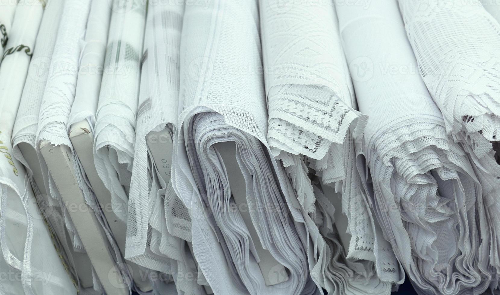 Detailed close up view on samples of cloth and fabrics in different colors found at a fabrics market photo