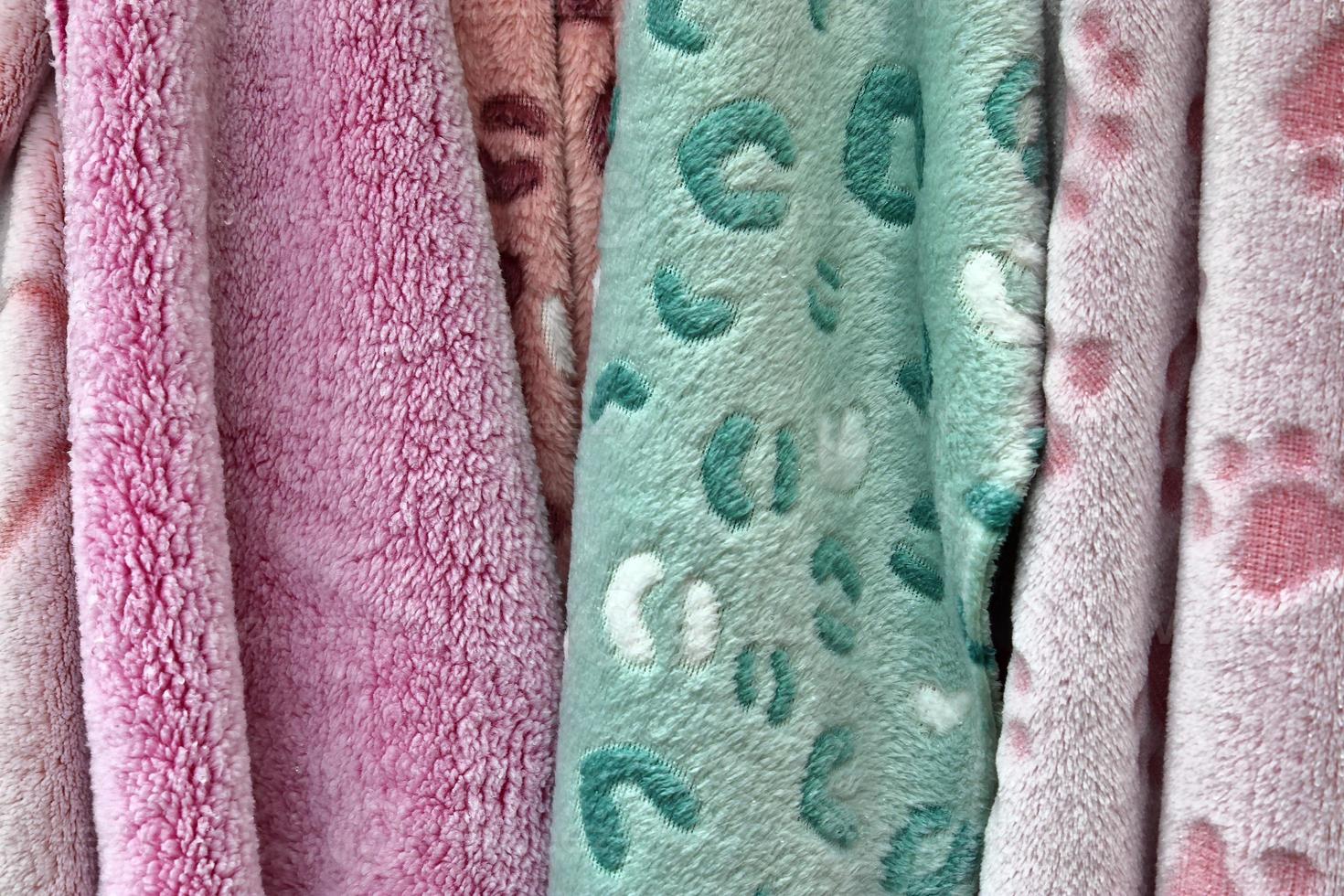 Detailed close up view on samples of cloth and fabrics in different colors found at a fabrics market photo